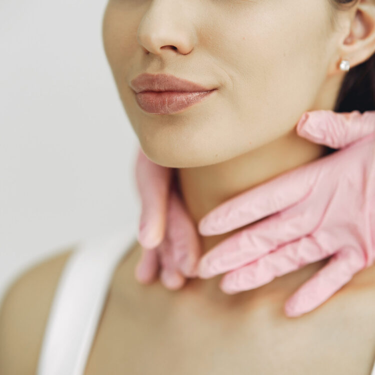 Cosmetologist holds hands near client's face. Woman with cosmetologist. Lady in a beauty studio.